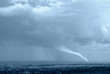 waterspout  with lightning incumbent  on the city