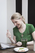 woman looking at laptop making thumbs up sign