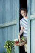 Photo: germany, bavaria, man in front of barn door holding basket with fresh vegetables, smiling, portrait germany, bavaria, man in front of barn door holding basket with fresh vegetables, smiling, portrait