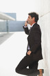 spain, mallorca, businessman using mobile phone, side view