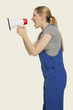 woman in overall shouting through megaphone, side view