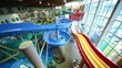 People rapidly slide down plastic hills in large water park People rapidly slide down plastic hills in large water park