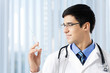Happy doctor with syringe at office
