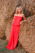 Beautiful blond young woman near haystack