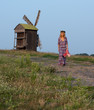 Beautiful blond young woman in a cowboy hat and dress