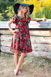 Beautiful barefoot blond young woman in a hat