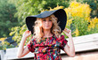 Beautiful blond young woman in the big hat