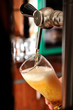 Filling glass with beer from faucet