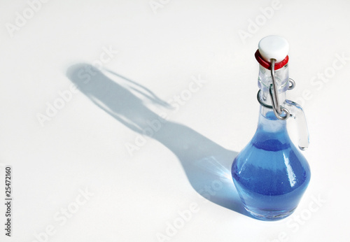 Photo: Small bottle full of blue color fluid Small bottle full of blue color fluid