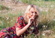 Beautiful blond woman with wild flowers