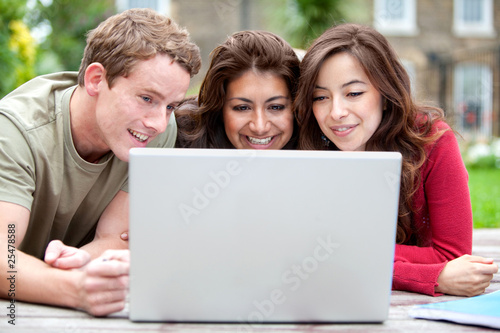People on a laptop outdoors