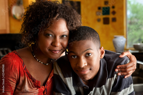 Photo: African-American woman with young man in kitchen African-American woman with young man in kitchen