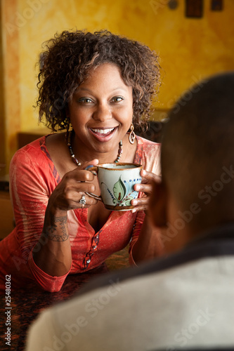 Photo: African-American woman and young man in kitchen African-American woman and young man in kitchen