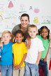 happy teacher and young preschool students