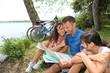Family on a bicycle ride looking at map