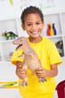 happy indian boy holding plastic dinosaur