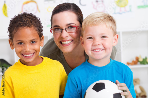 Photo: happy preschool teacher with two boys in classroom happy preschool teacher with two boys in classroom