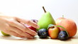 woman selects fruit.
