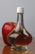 Bottle with apple vinegar and fresh apple. Shallow dof