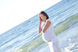 Beautiful expectant girl on the beach.