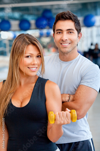 Photo: gym woman and trainer gym woman and trainer