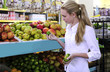 Woman shopping for fruits in the supermarket