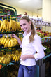 Woman shopping for fruits in the supermarket