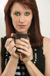 Beautiful female with green eyes drinking coffee
