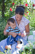 Foto: Mother giving homeoptahic medicine to her son Mother giving homeoptahic medicine to her son