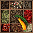 Assortment of peppercorns and chili in wooden box