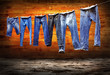 Jeans on a clothesline to dry on the grunge background Jeans on a clothesline to dry on the grunge background