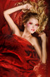 Portrait of beautitful nude young woman in red bed