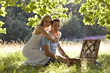 A young couple having a picnic, embracing