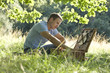 A young man opening a picnic basket