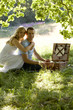 A young couple having a picnic, embracing