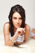 Portrait of attractive nude girl covering your body by silk