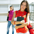 Female college friends talking on campus Female college friends talking on campus