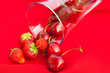 glass of cherry and strawberry on a red background glass of cherry and strawberry on a red background