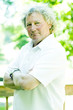 middle age senior man portrait tennis shirt long hair boomer