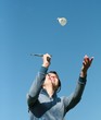 Badminton player-girl tossing up a shuttlecock