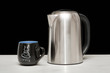 One mettal kettle and coffee cup One mettal kettle and coffee cup
