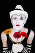 mime in white hat with bouquet of red gerberas mime in white hat with bouquet of red gerberas