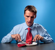 Photo: young man eating his red tie young man eating his red tie