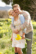 Romantic Couple Walking Amongst Spring Daffodils Romantic Couple Walking Amongst Spring Daffodils