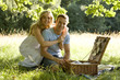A young couple having a picnic, embracing