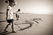 Kids writing in sand