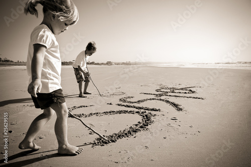 Photo: Kids writing in sand Kids writing in sand