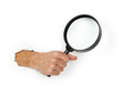 Hand holding magnifying glass on white