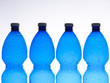 bottles of blue plastic in row