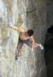 Free climber holding on the cliff, view from above